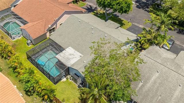 an aerial view of residential houses with outdoor space and swimming pool