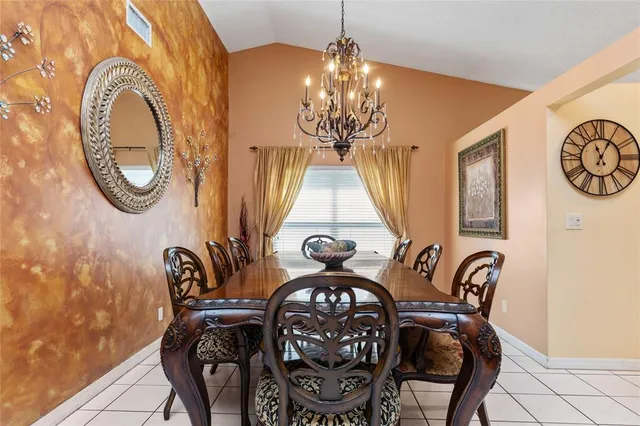 a view of a dining room with furniture and chandelier