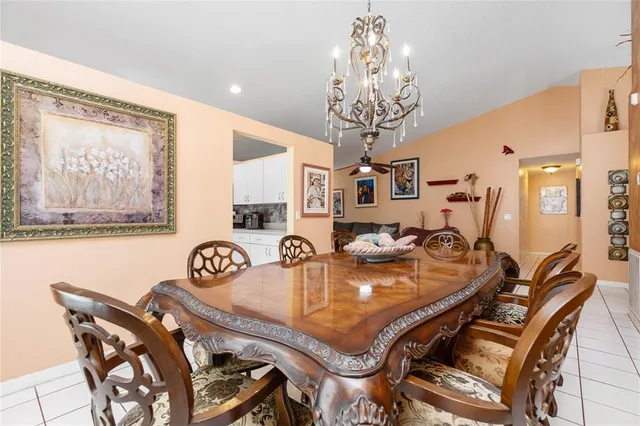 a living room with furniture a chandelier and a window