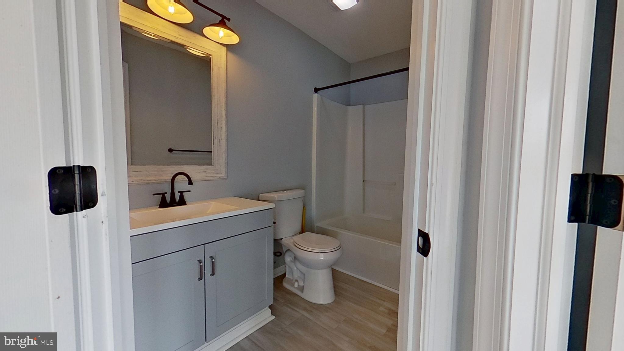 450 Fisher Drive York, PA 17404 - Photo 10 of 12 a bathroom with a toilet a sink and mirror