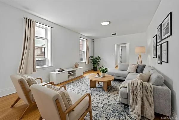 a living room with furniture fireplace and a window