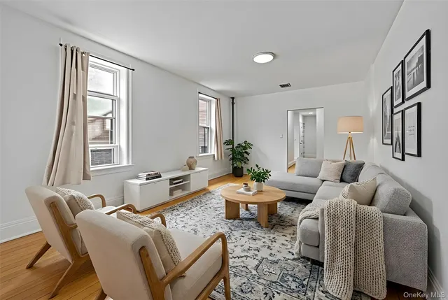 a living room with furniture fireplace and a window