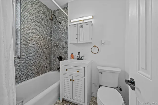a bathroom with a sink a toilet and bathtub