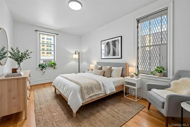 a bedroom with a large bed and a potted plant