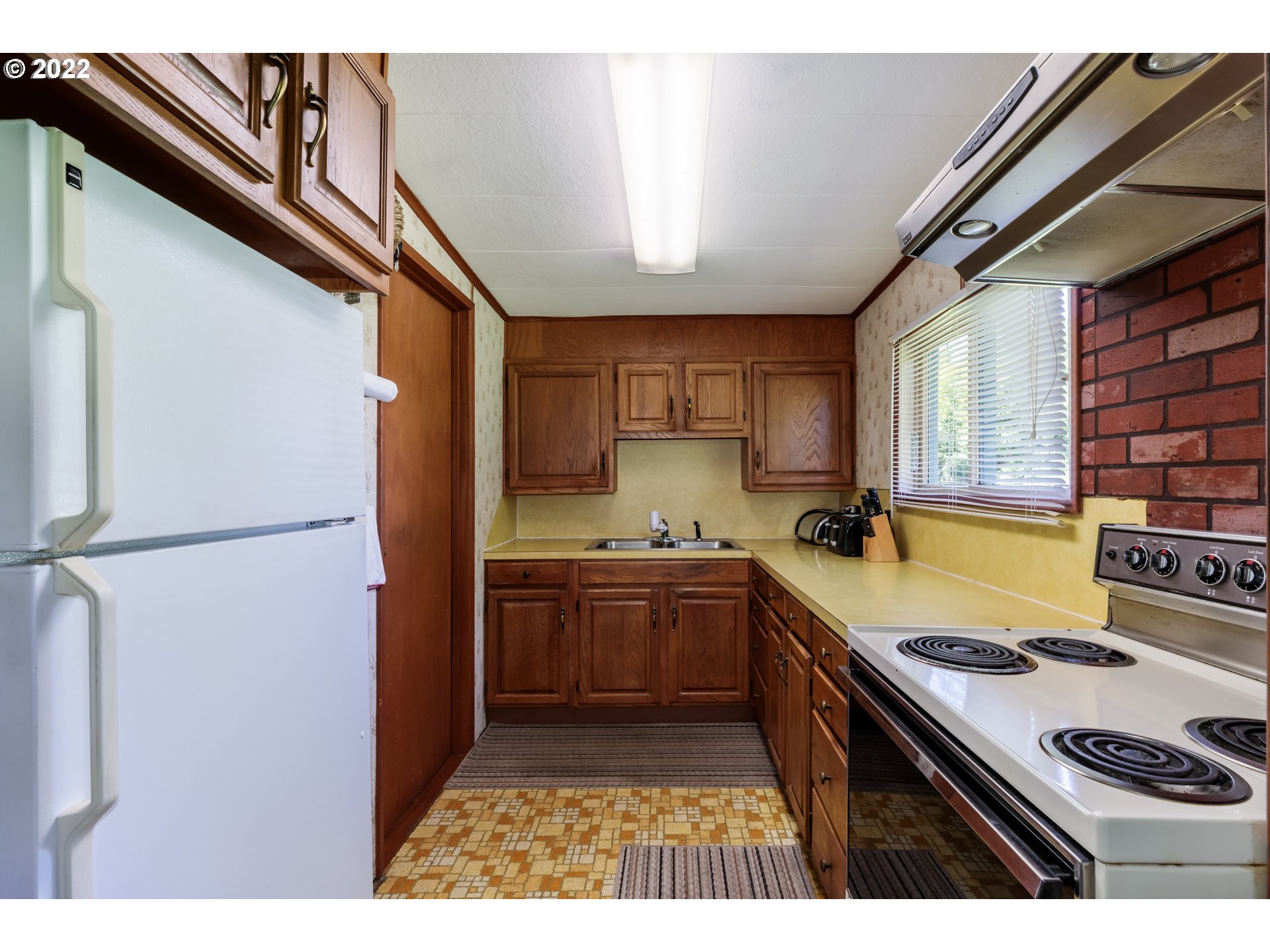67954 Andy Thomas Road Rainier, OR 97048 - Photo 5 of 14 a kitchen with stainless steel appliances granite countertop a refrigerator a sink dishwasher a stove and white countertops with wooden floor