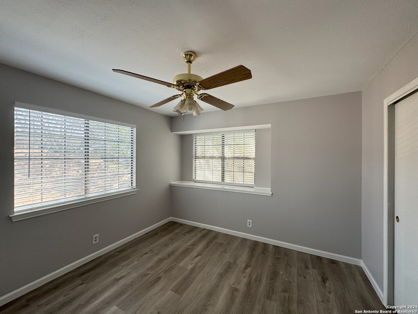 5939 Heather View San Antonio, TX 78249 - Photo 13 of 31 a view of an empty room with wooden floor and a window