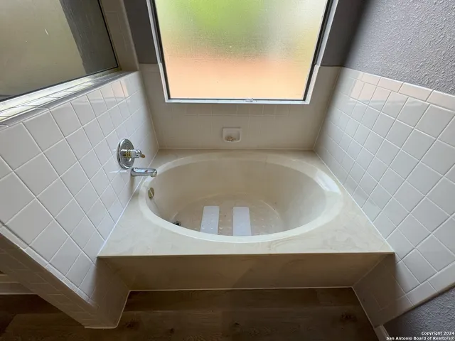 a sink sitting in a bathroom next to a window