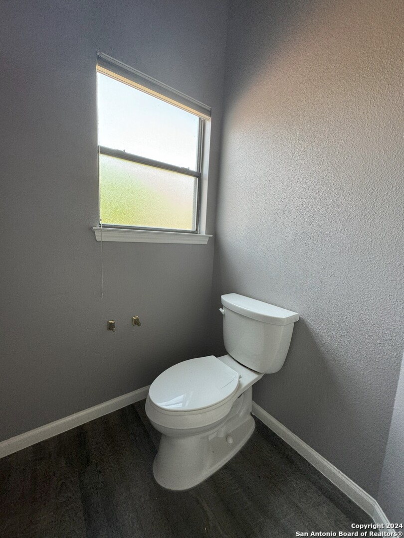 5939 Heather View San Antonio, TX 78249 - Photo 24 of 31 a white toilet sitting next to a window in a bathroom