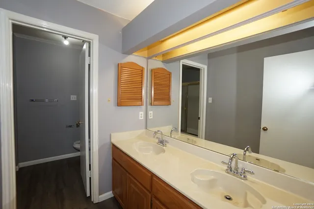 a bathroom with a double vanity sink and mirror