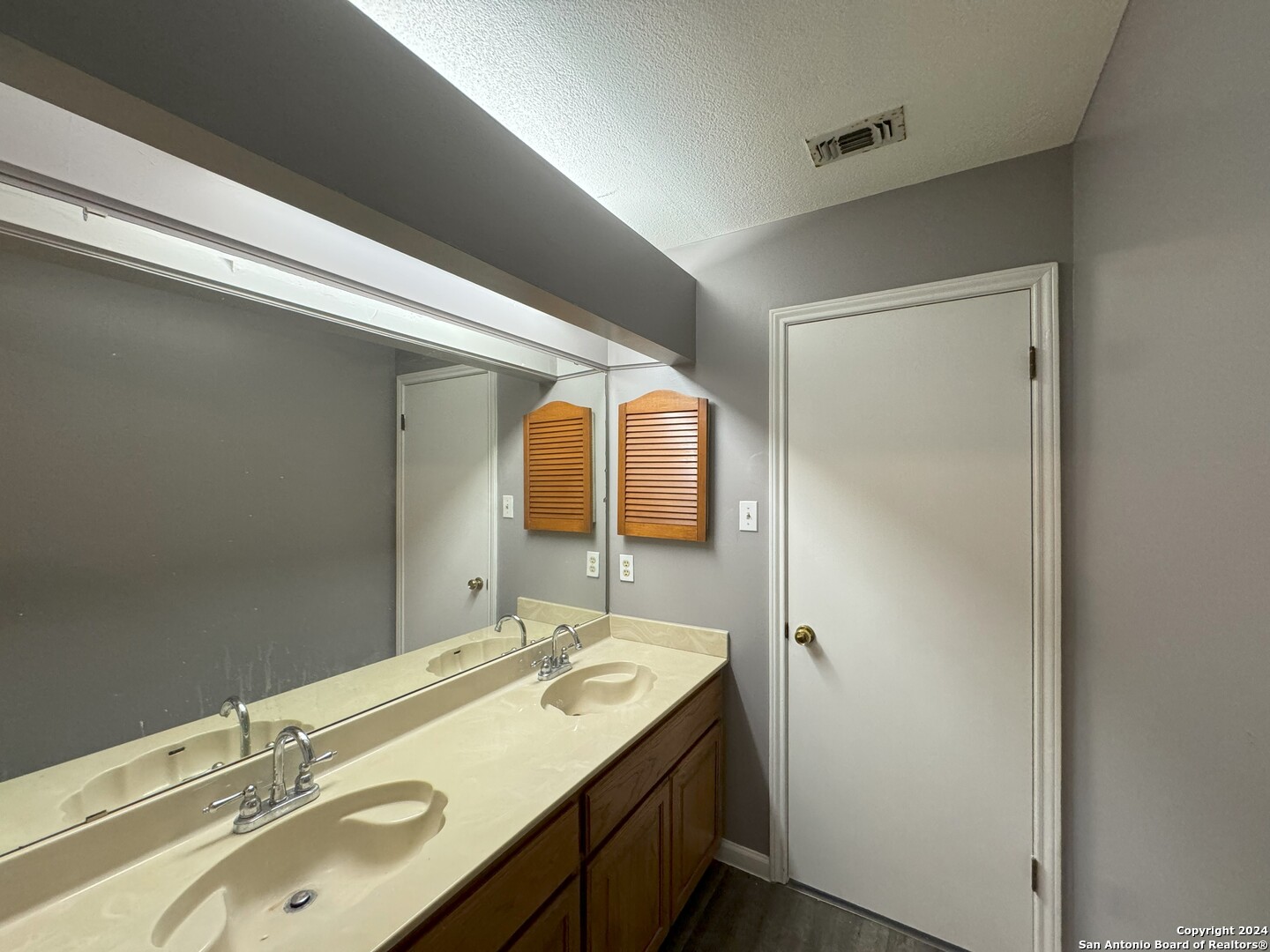 5939 Heather View San Antonio, TX 78249 - Photo 28 of 31 a bathroom with a double vanity sink and mirror