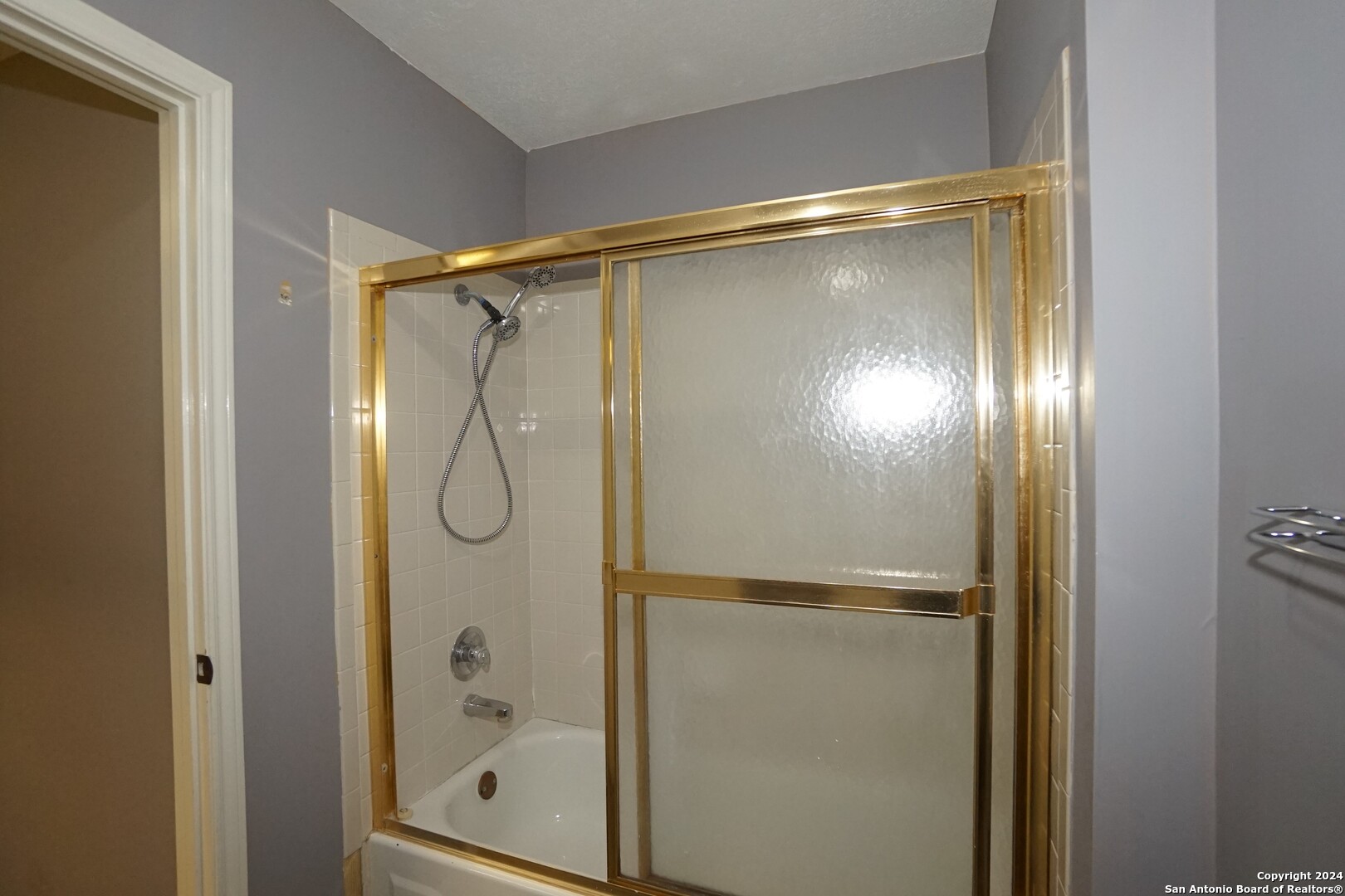 5939 Heather View San Antonio, TX 78249 - Photo 29 of 31 a bathroom with a glass shower door