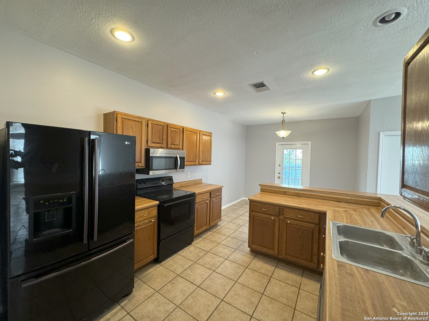 5939 Heather View San Antonio, TX 78249 - Photo 5 of 31 a kitchen with stainless steel appliances granite countertop a refrigerator and a sink