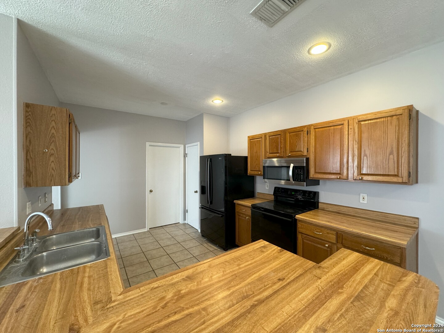 5939 Heather View San Antonio, TX 78249 - Photo 6 of 31 a bedroom with a bed and furniture