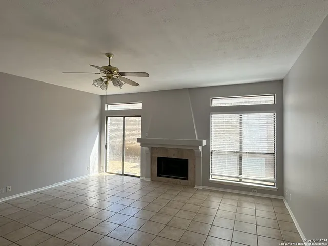 a view of an empty room with glass door and a window