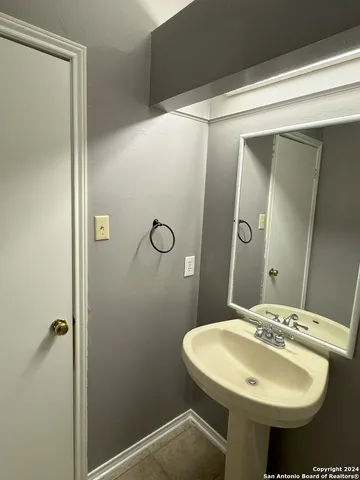 a bathroom with a sink mirror and toilet