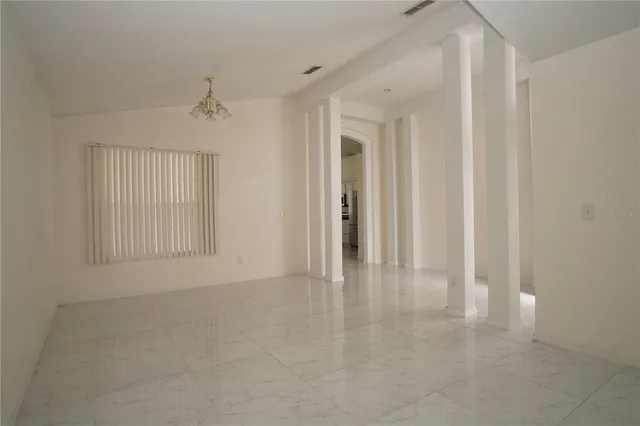 a view of an empty room with a window