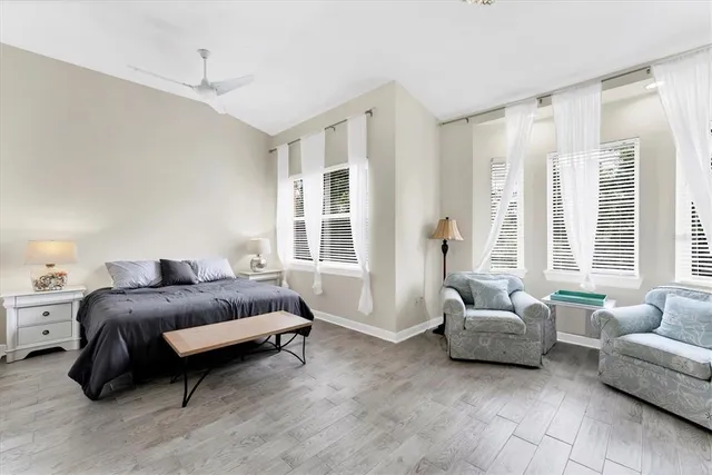 a spacious bedroom with a bed and a chandelier