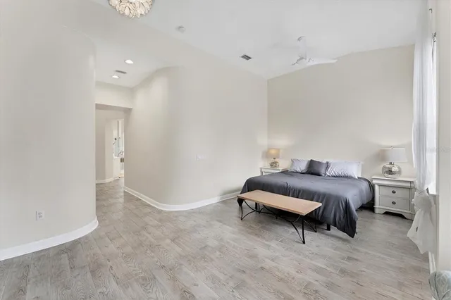 a bedroom with a bed and a large window