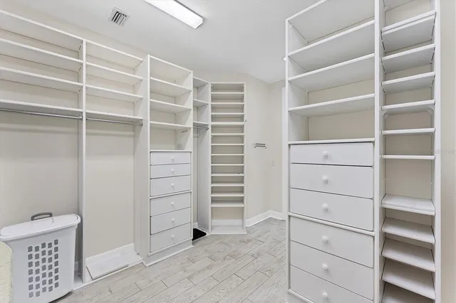 a spacious bathroom with a double vanity sink a mirror a and a shower