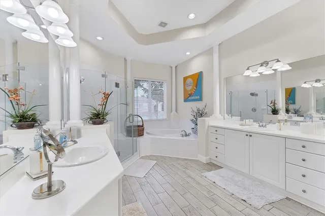 a bathroom with a tub sink and mirror