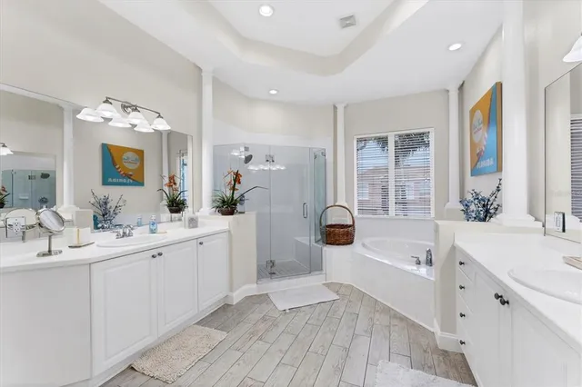 a bathroom with a double vanity sink mirror and shower