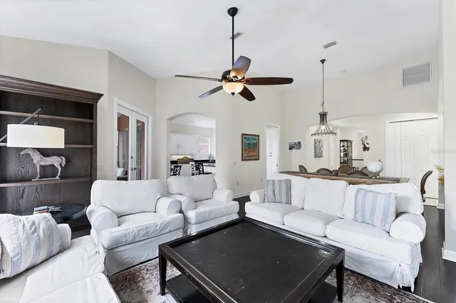 a view of a dining room with furniture wooden floor and chandelier