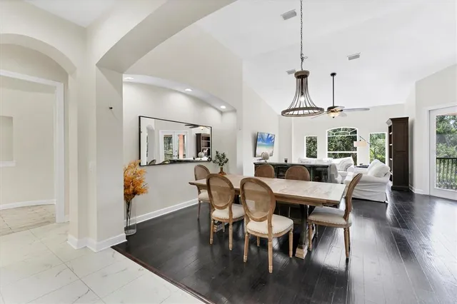 a view of a dining room with furniture wooden floor and chandelier