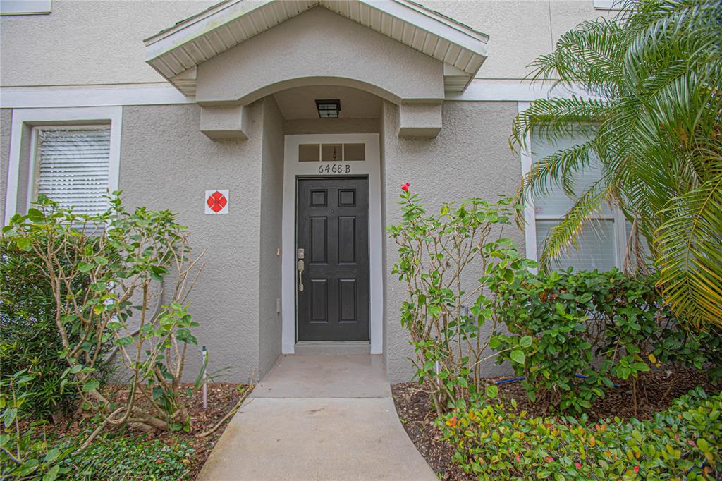 6468 South Goldenrod Road, Unit 34B Orlando, FL 32822 - Photo 1 of 34 a front view of yellow house with plants