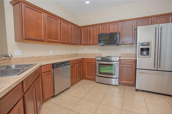 a kitchen with a sink a stove and refrigerator