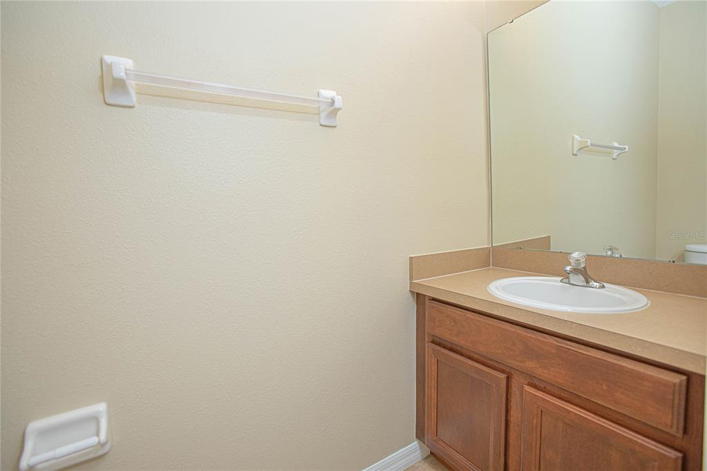 6468 South Goldenrod Road, Unit 34B Orlando, FL 32822 - Photo 16 of 34 a bathroom with a granite countertop sink and a mirror
