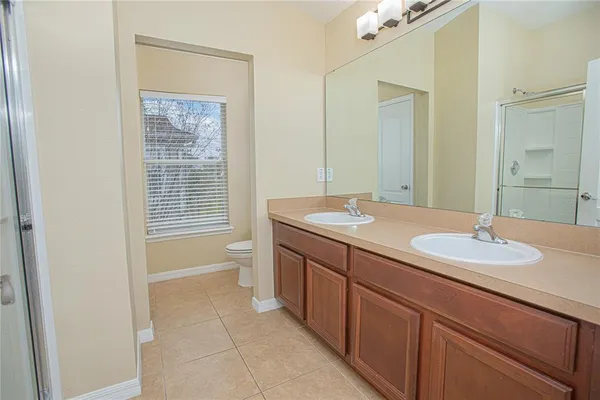 a bathroom with a granite countertop sink a toilet and a mirror