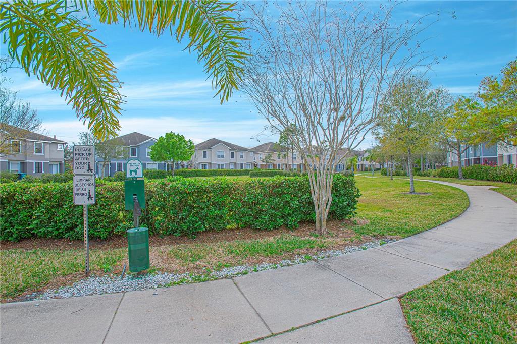 6468 South Goldenrod Road, Unit 34B Orlando, FL 32822 - Photo 31 of 34 a view of a garden with a tree in front of the house