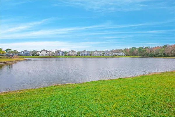 a view of a lake with houses in the back
