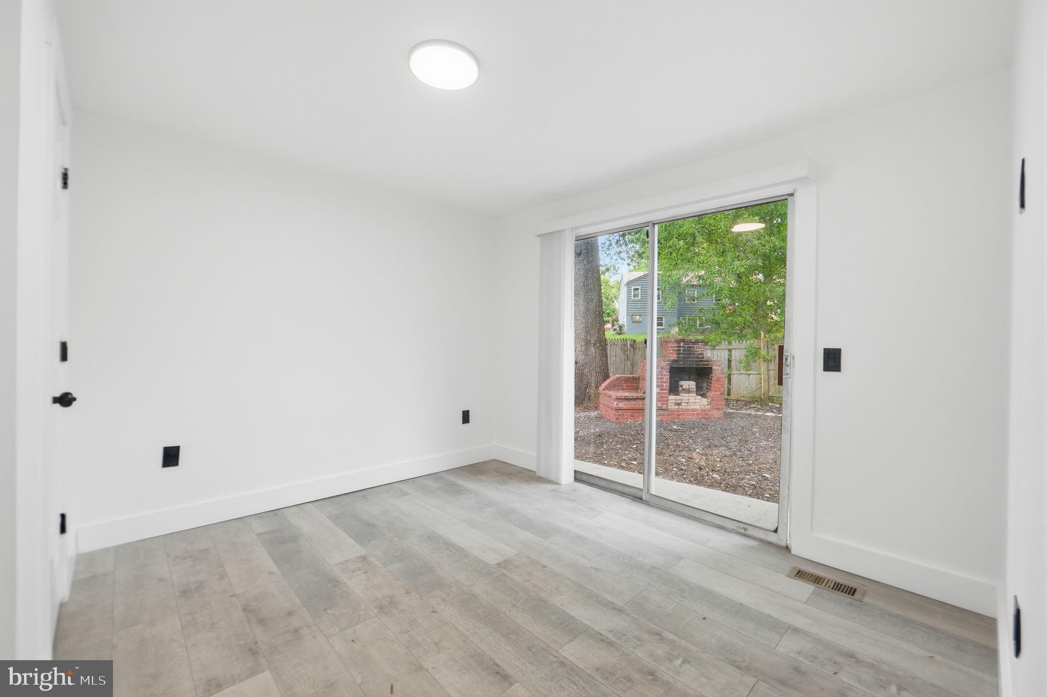 5906 Berwyn Road College Park, MD 20740 - Photo 22 of 46 an empty room with sliding glass door