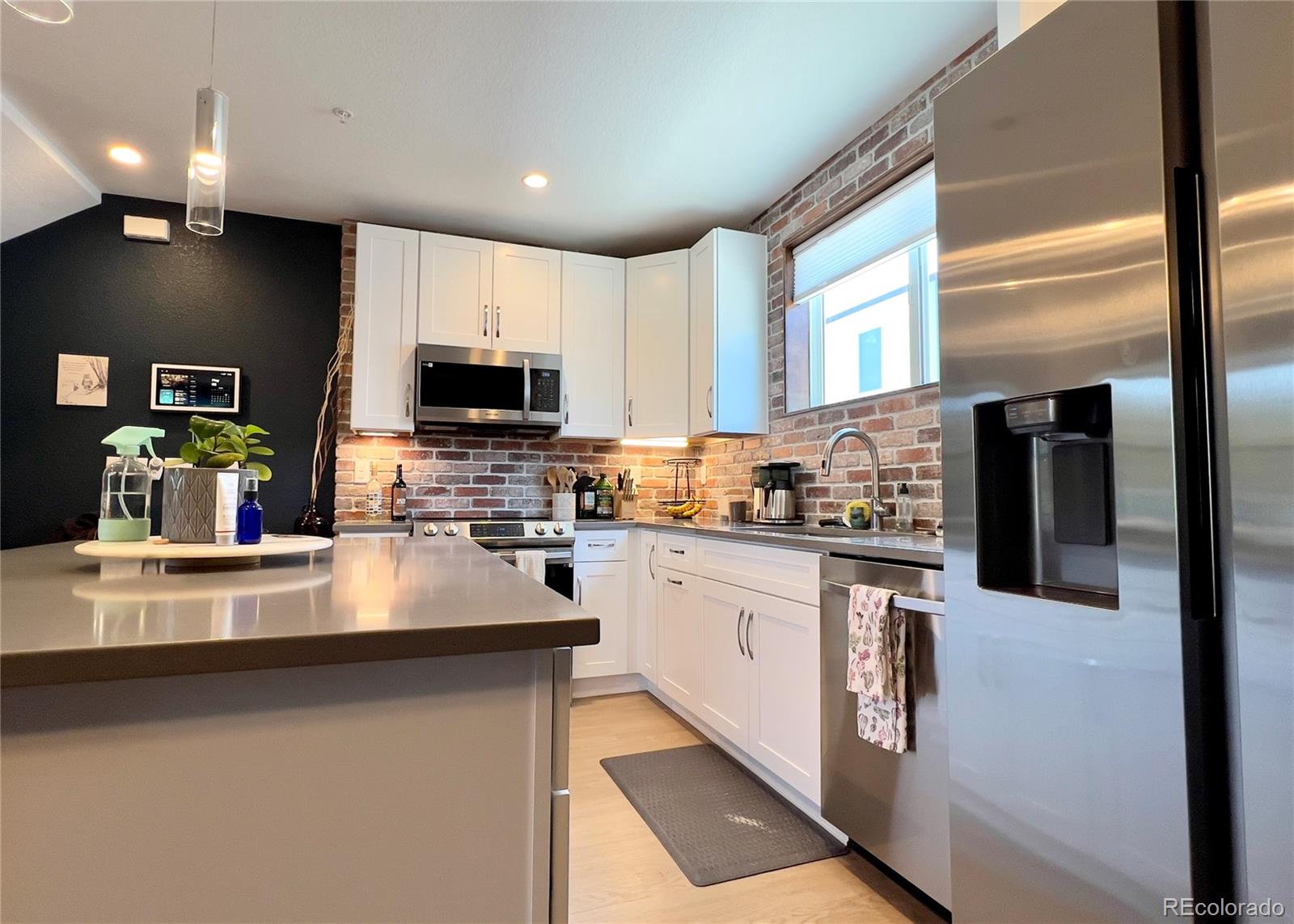 6228 West 38th Avenue Wheat Ridge, CO 80033 - Photo 6 of 38 a kitchen with stainless steel appliances a stove sink microwave and cabinets