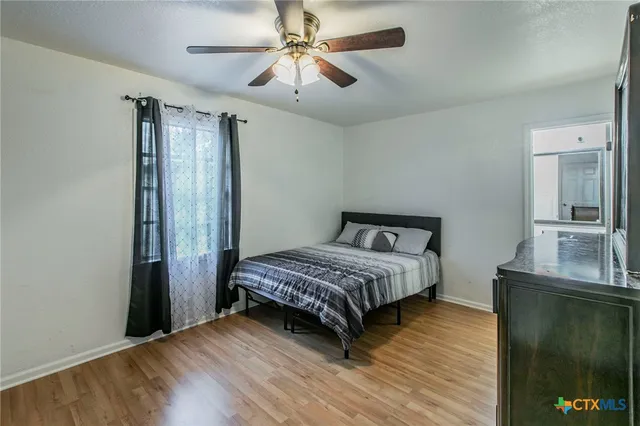 a bedroom with a bed and a mirror