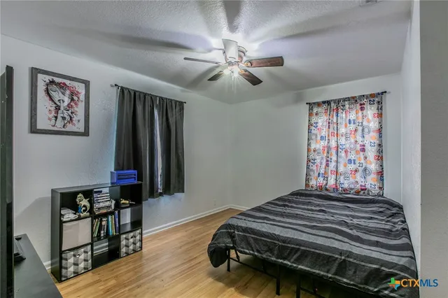 a bedroom with bed and a window