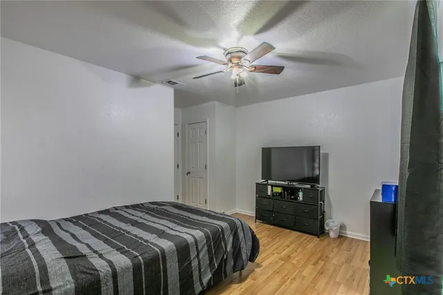 a bedroom with a bed and a television