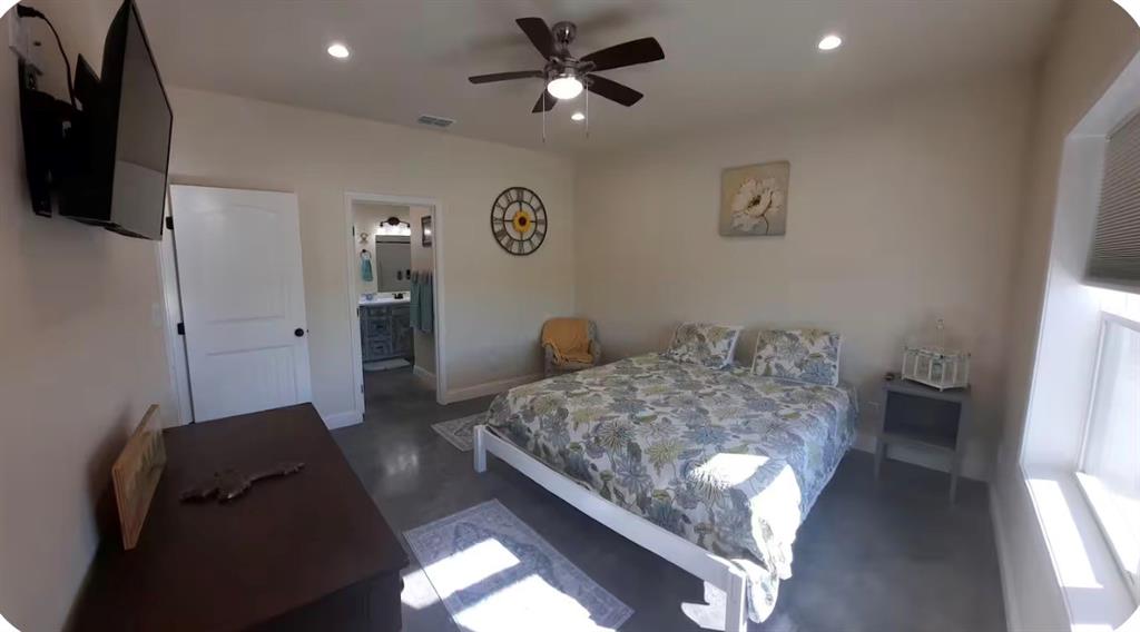 7565 Fm 3116 Anson, TX 79501 - Photo 7 of 15 Spacious bedroom featuring concrete flooring, recessed lighting, and a ceiling fan