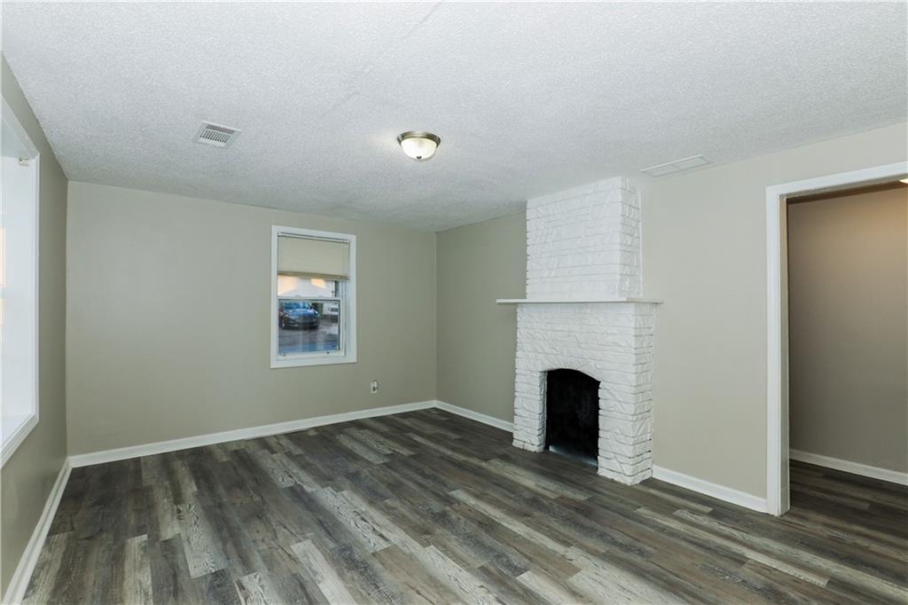335 Mount Zion Road Southwest Atlanta, GA 30354 - Photo 2 of 11 an empty room with fireplace and a window