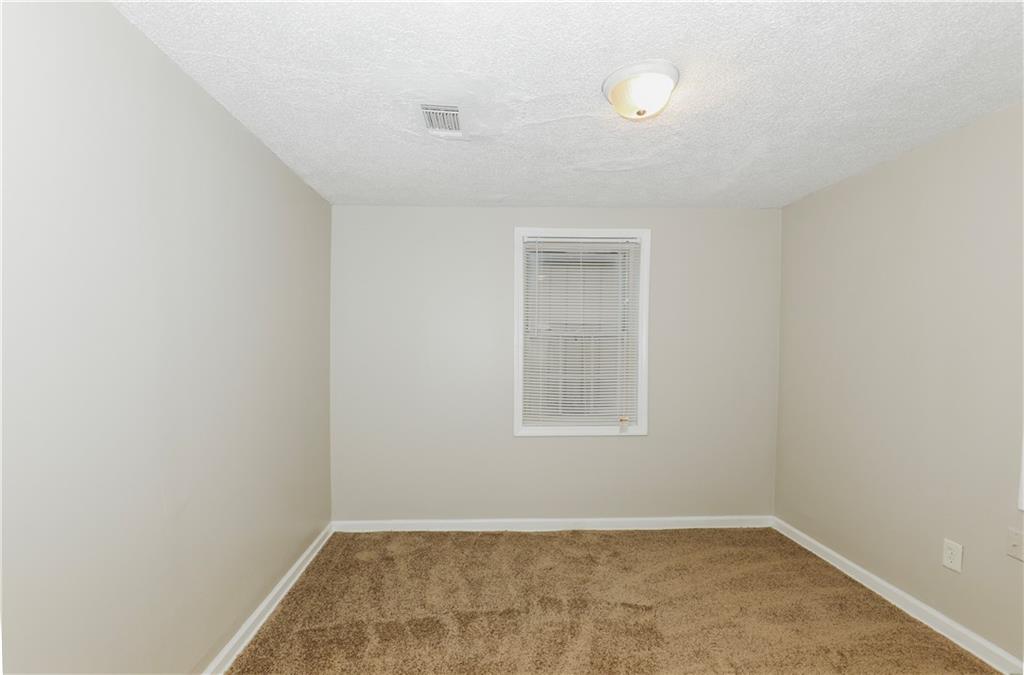 335 Mount Zion Road Southwest Atlanta, GA 30354 - Photo 3 of 11 an empty room with a window