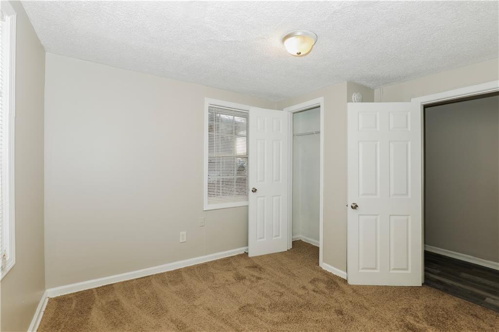 335 Mount Zion Road Southwest Atlanta, GA 30354 - Photo 4 of 11 an empty room with windows
