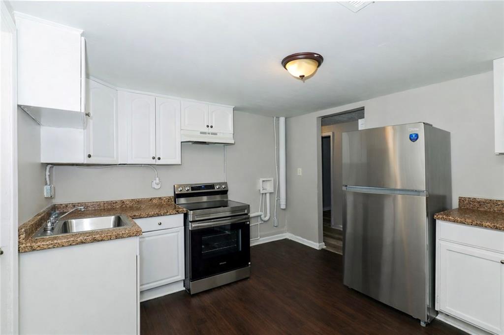 335 Mount Zion Road Southwest Atlanta, GA 30354 - Photo 7 of 11 a kitchen with a refrigerator and a stove top oven