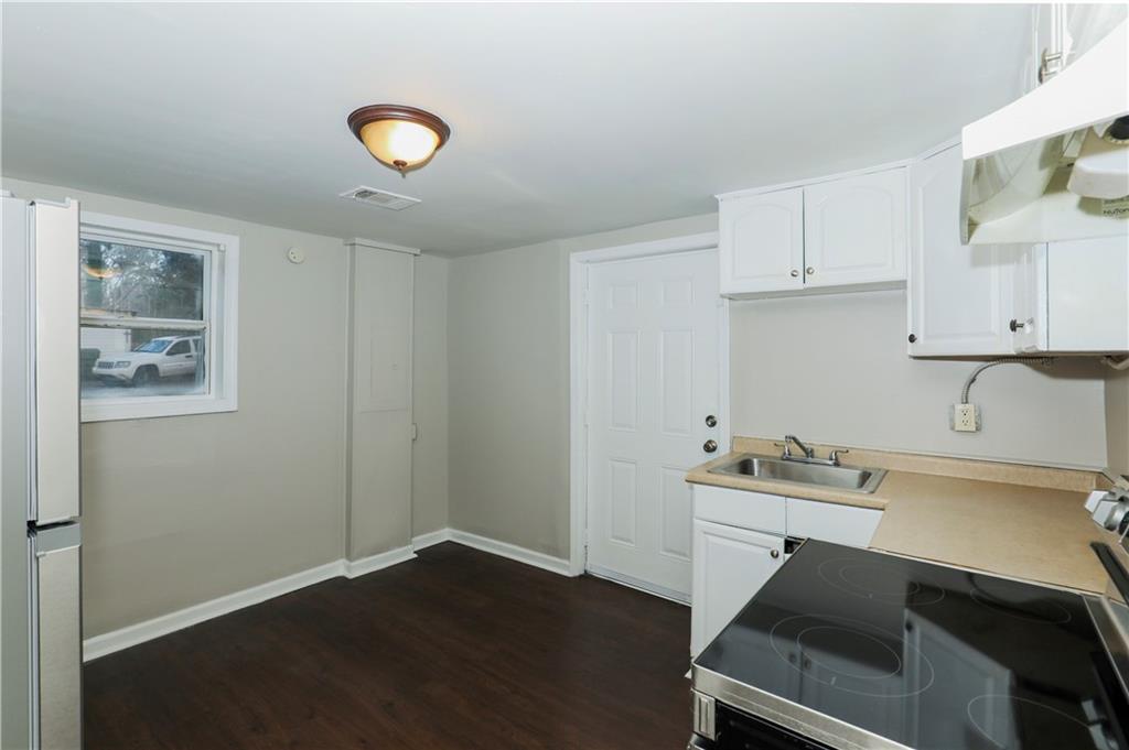 335 Mount Zion Road Southwest Atlanta, GA 30354 - Photo 8 of 11 a kitchen with a sink cabinets and wooden floor