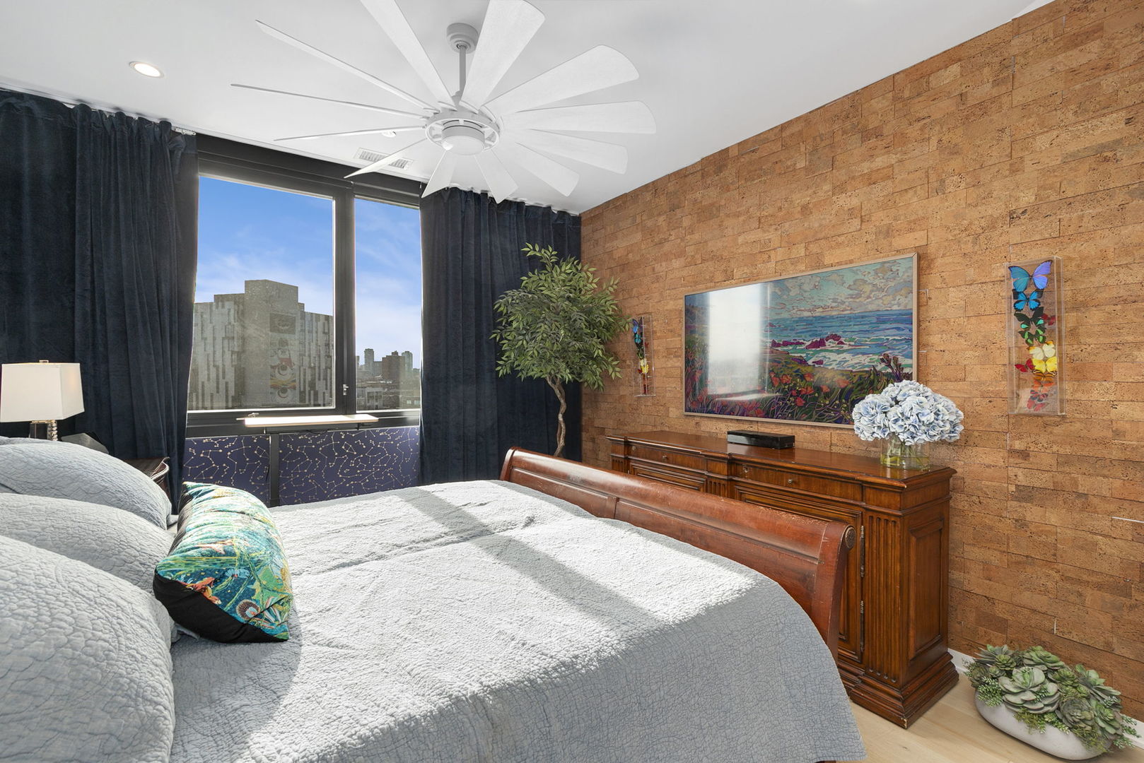 1648 West Division Street, Unit 703 Chicago, IL 60622 - Photo 16 of 41 a bedroom with a large bed and a chandelier