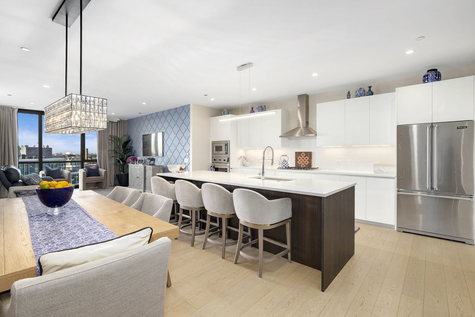 1648 West Division Street, Unit 703 Chicago, IL 60622 - Photo 3 of 41 a kitchen with stainless steel appliances granite countertop a table chairs and a refrigerator