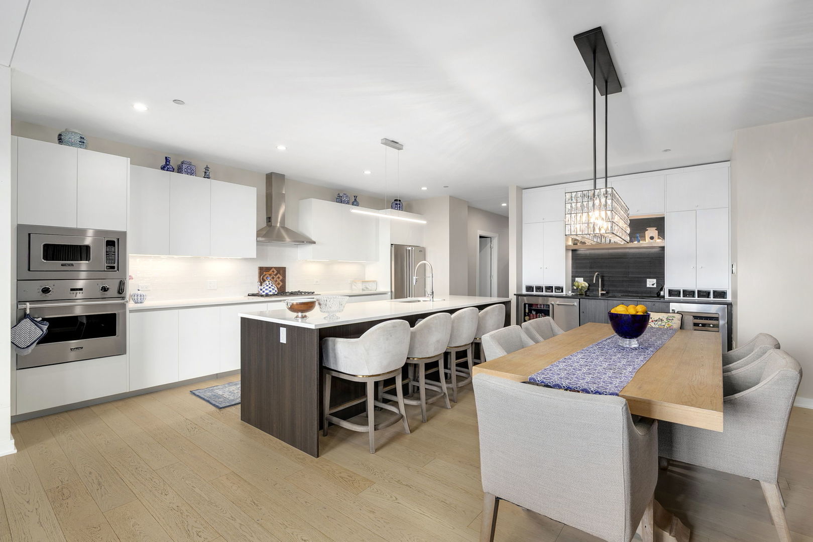 1648 West Division Street, Unit 703 Chicago, IL 60622 - Photo 4 of 41 a kitchen with a dining table chairs and refrigerator