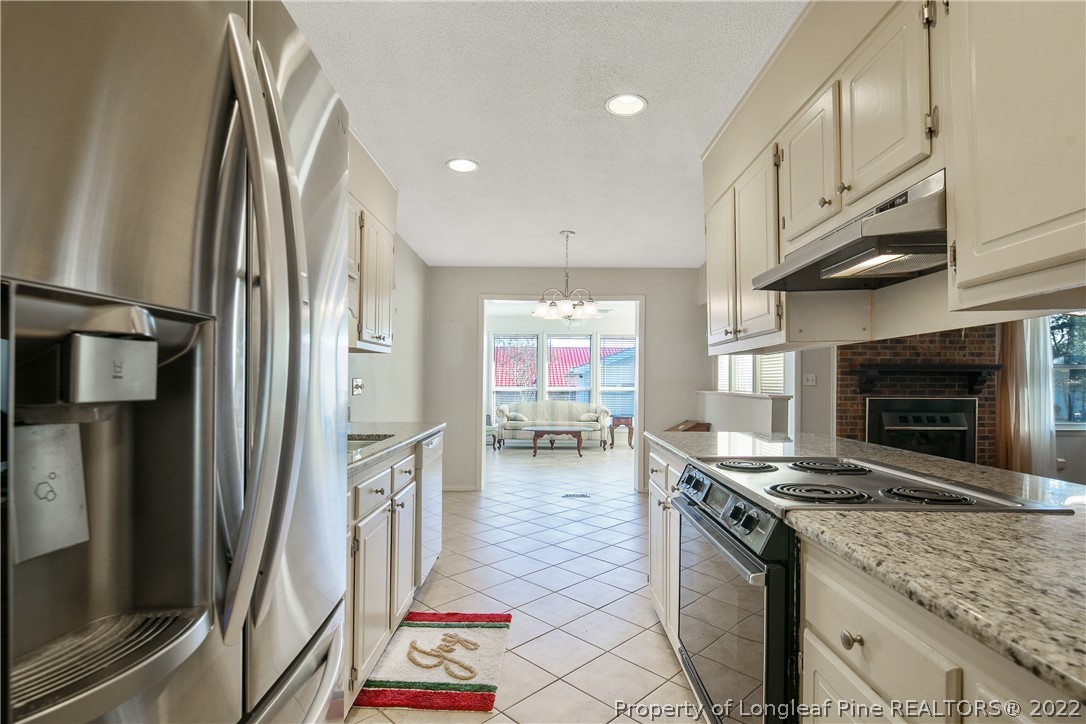 211 Duncan Road Spring Lake, NC 28390 - Photo 13 of 46 a kitchen with stainless steel appliances granite countertop a refrigerator a stove and a sink