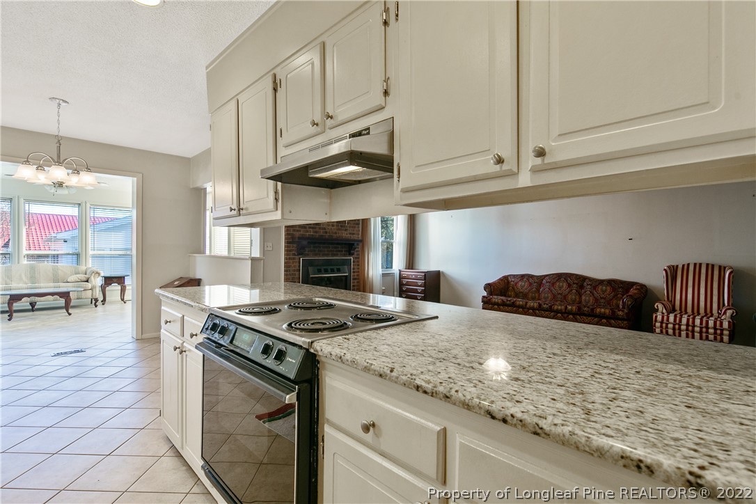 211 Duncan Road Spring Lake, NC 28390 - Photo 14 of 46 a kitchen with stainless steel appliances granite countertop a stove a sink and a white cabinets