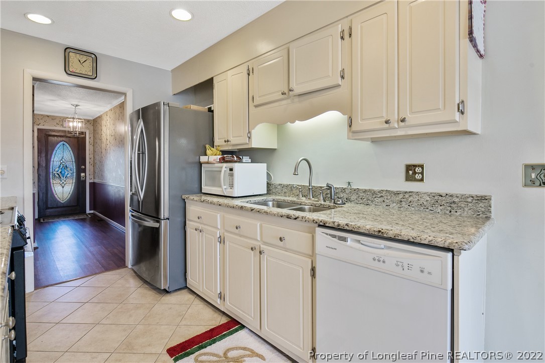 211 Duncan Road Spring Lake, NC 28390 - Photo 18 of 46 a kitchen with stainless steel appliances granite countertop a refrigerator sink and cabinets